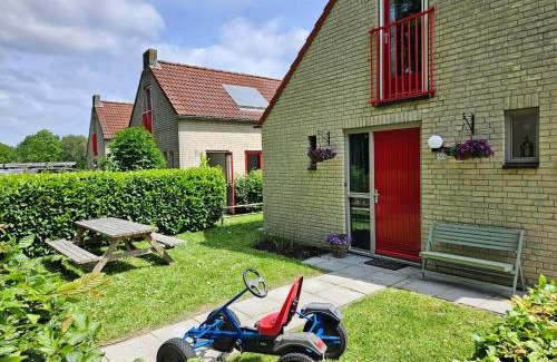 Ewijk House | 7 person House with swing, firepit, hammock, garden, swimming lake, child friendly, in- and outside playground, and great coffee