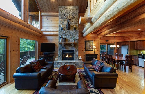 Almond Cabin | Antler Ridge - a stunning log cabin with spacious deck equipped with outdoor fireplace, hot tub, and scenic mountain views!