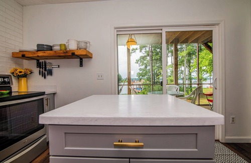 North Shore Acres House | Beautiful lake front cottage, deep water lot with covered dock and amenities.