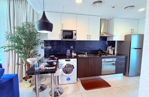Al Hoora Apartment | Blue Seaview 75 inch Smart TV 1Br
