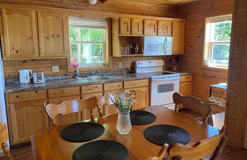 Borden-Carleton Cottage | Cozy cabin style cottage tucked into the woods with a view of the water.