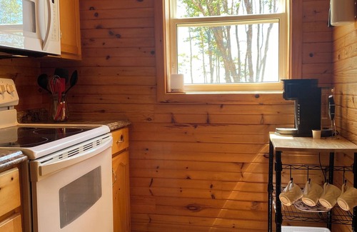 Borden-Carleton Cottage | Cozy cabin style cottage tucked into the woods with a view of the water.