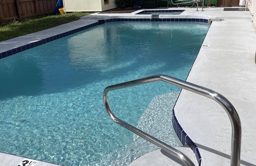 Lake Worth Apartment | Cozy room with pool and patio.