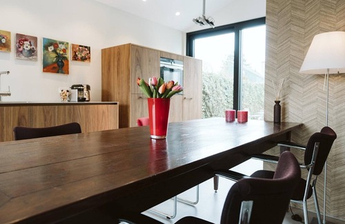 Ouddorp House | Doggersbank 38 is a luxurious and stylish holiday home with an elegant interior, spacious garden, and cozy wood stove for ultimate comfort by the sea.