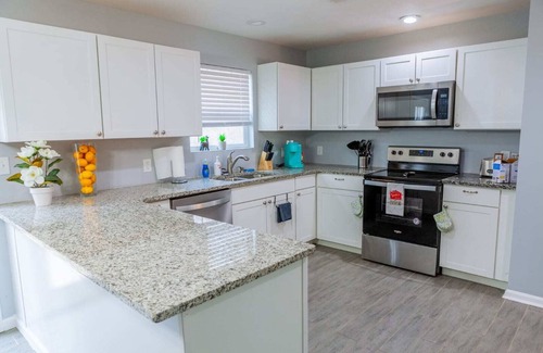 Fairburn House | Elegant Haven: Stylish Interiors with Serene Deck Views and Modern Comforts