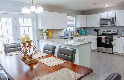 Fairburn House | Elegant Haven: Stylish Interiors with Serene Deck Views and Modern Comforts