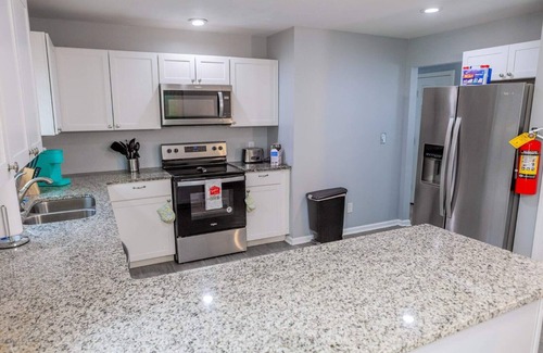 Fairburn House | Elegant Haven: Stylish Interiors with Serene Deck Views and Modern Comforts