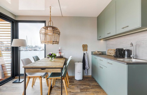 Grou Boat Rental | Houseboat Skoft with beautiful view over the water and on village Grou.