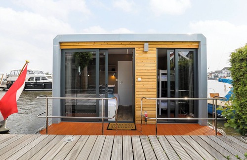 Grou Boat Rental | Houseboat Skoft with beautiful view over the water and on village Grou.