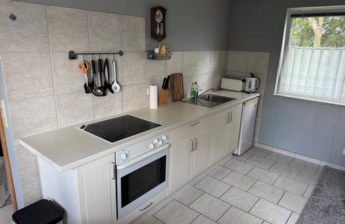 Stuthof House | Idyllic bungalow surrounded by greenery, perfect for relaxing.