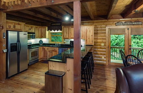 Sylva Cabin | Log cabin with large decks on the Bank of the Tuckasegee River.