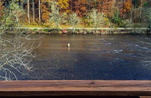 Sylva Cabin | Log cabin with large decks on the Bank of the Tuckasegee River.