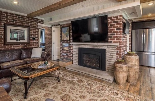 Otisco House | Luxury waterfront home. Fireplaces, patios & views