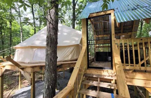 Denton House | Mountain Bell tent Tree house providing views of surrounding mountains and lake.