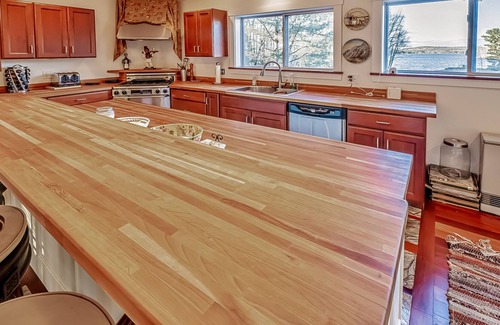 Belfast House | Ornate lake view home with wraparound deck, dock access & W/D