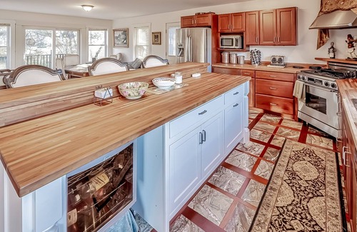 Belfast House | Ornate lake view home with wraparound deck, dock access & W/D