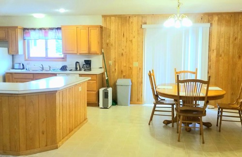 Grand Rapids Cabin | Private cabin in the woods near a serene creek and towering pine trees.