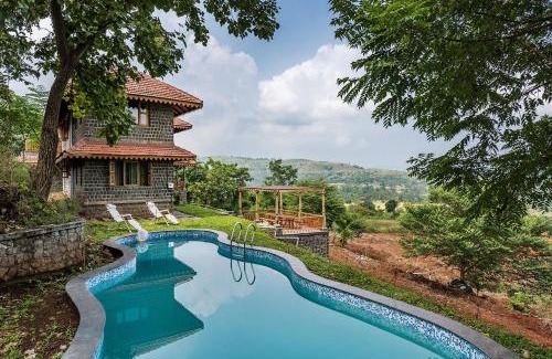 Ambavna Villa | SaffronStays Niramay, Torna-Rajgad - rustic pool villa with a gazebo and great forest views