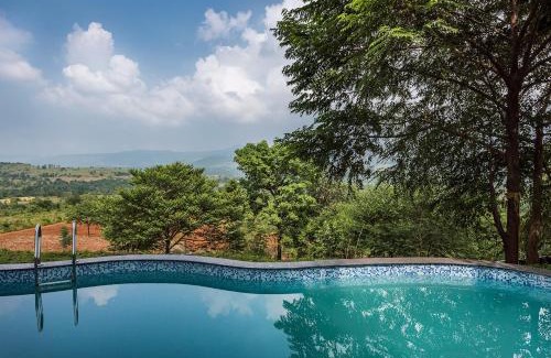 Ambavna Villa | SaffronStays Niramay, Torna-Rajgad - rustic pool villa with a gazebo and great forest views