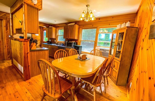 Johnsburg House | Secluded Log Cabin with hot-tub. Near Lake George. Amazing Mt View. Sleeps 15