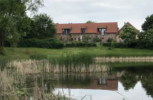 Hirschfelde House | Stylishly furnished fieldstone barn with dining room and terrace by the village pond