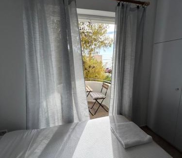 Saronida Apartment | Sunny Modern Beach Retreat Steps from the Shore