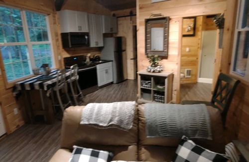 Darlington House | The Chalet is located in the woods of a gated property with a covered porch.