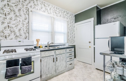 Manhattan House | Walk To Aggieville from Brick Cottage with Man Cave, Shuffle Board, Back Yard