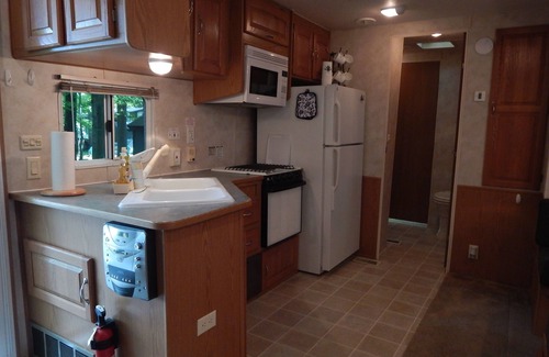 Bliss RV Rental | Waterfront camper in Adirondack-like setting