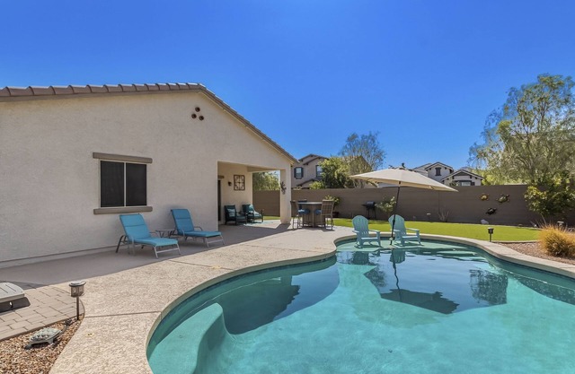 Airy desert home with an enclosed yard, private pool, hot tub, firepit, & W/D