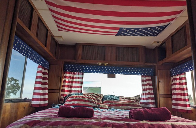 'Arvey the American RV, parked on a picturesque campsite with its own garden
