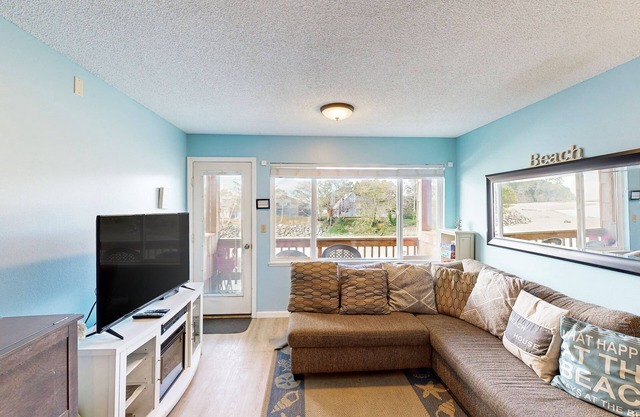 Creekside condo with beach access, balcony, full kitchen, & ocean views