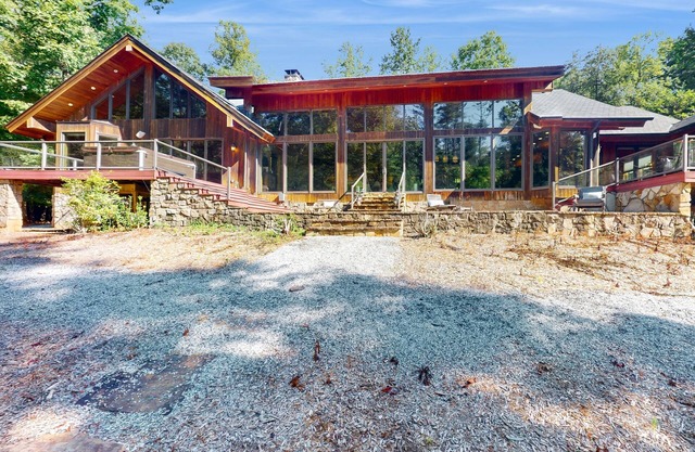 Custom riverfront retreat with private pond, dock, firepit & outdoor living