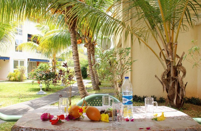 green setting, with pool and beach nearby.