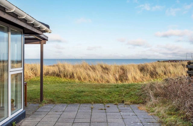 In the 1st row of dunes and with sea view to the Kattegat, this bright and cozy vacation home in Str