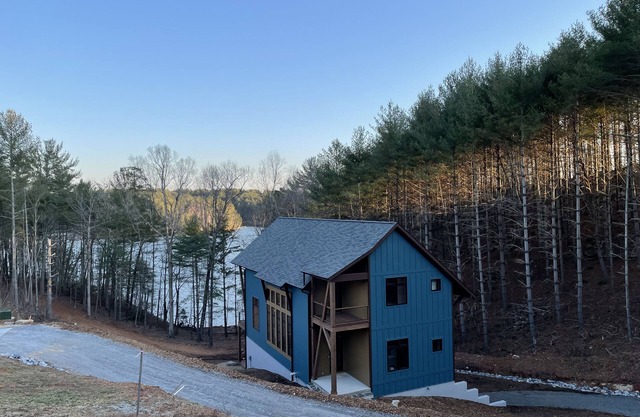Lake front home with dock in a small cove with a beach.
