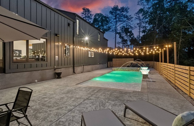 Luxury cabin lined by trees with pool, oversized sunroom, hot tub & grill