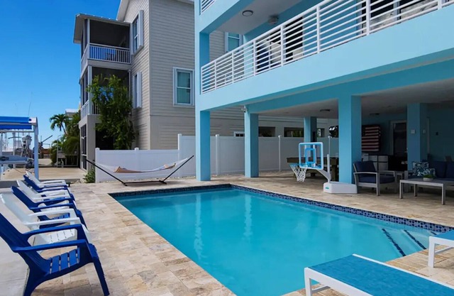 Modern 4 bedroom Keys home “Salt Life” with a pool. This home is on the Canal.
