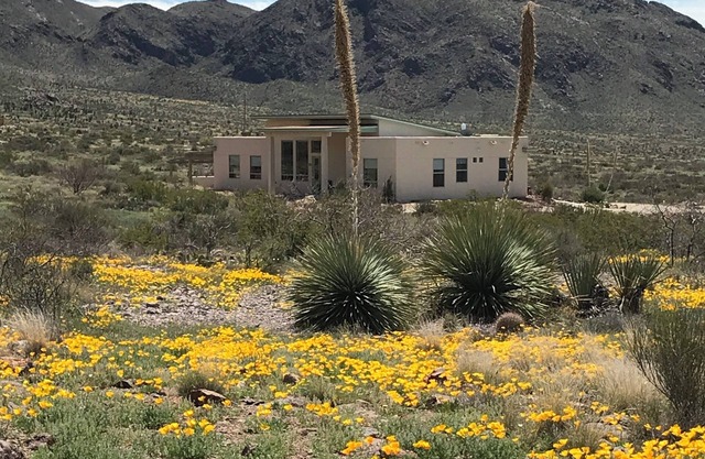 Modern home boarding desert wilderness and National Organ Mountain Monument .n