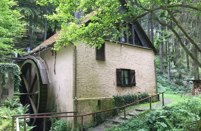 Old farm mill with a water wheel rebuilt as a vacation home