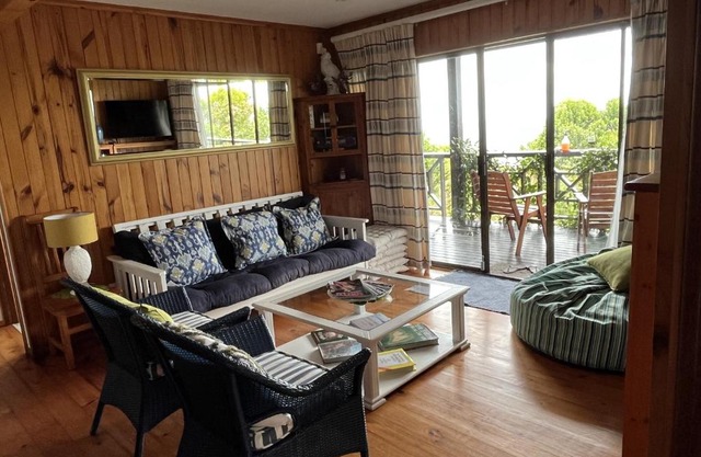 Peaceful guest suite with balcony views and garden setting