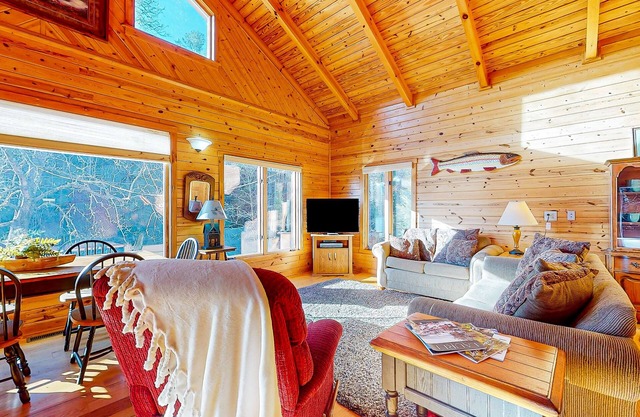 Rustic two-story lakefront cabin near beach with dock, lake & mtn views, & deck