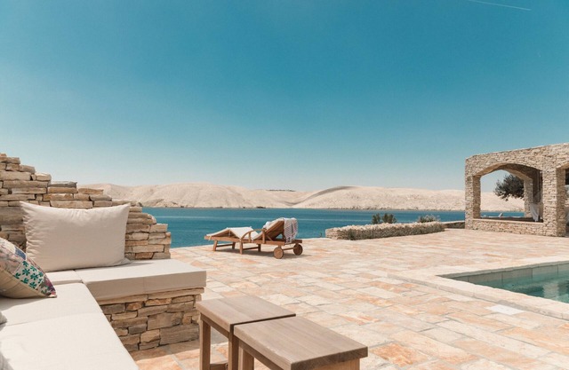 Seafront stone house with a pool