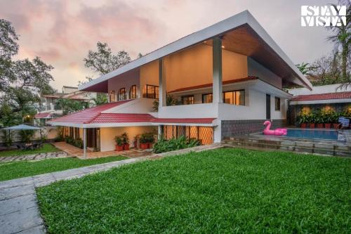 StayVista's Casa Ember - Relax with a Pool Table, Gazebo, and Inviting Swimming Pool