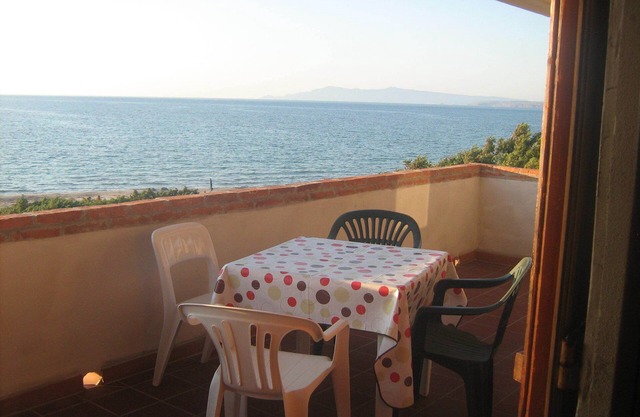 The Sound of the Sea. House on the beach, surrounded by greenery, Sardinia.