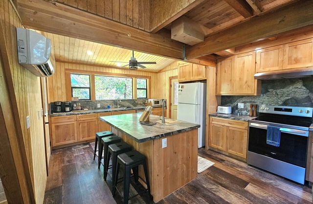 Tucked in the trees, Cedar Hill is a cozy A-frame cabin with modern updates, a spacious kitchen, wraparound deck, and stunning views. The perfect mountain escape for families, couples, and friends—plus, it's pet-friendly!