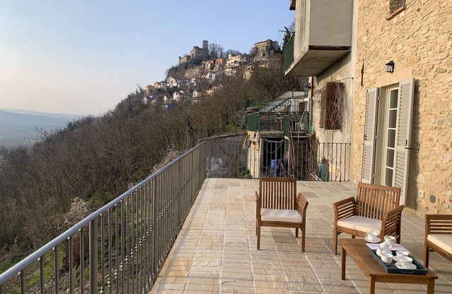 Two imposing houses set round an enclosed courtyard in ancient hill-top village