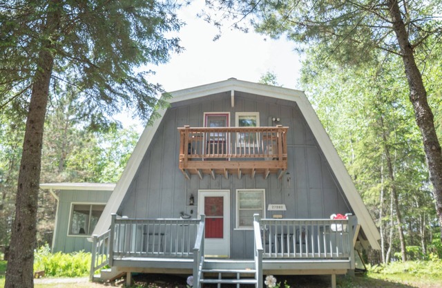 Unique modified A-frame cabin with loft, sandy lakefront, and amenities of home.