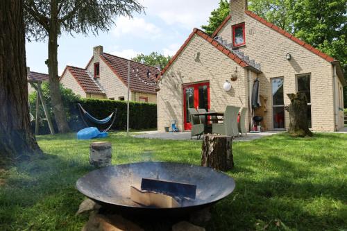 Ewijk House | 7 person House with swing, firepit, hammock, garden, swimming lake, child friendly, in- and outside playground, and great coffee