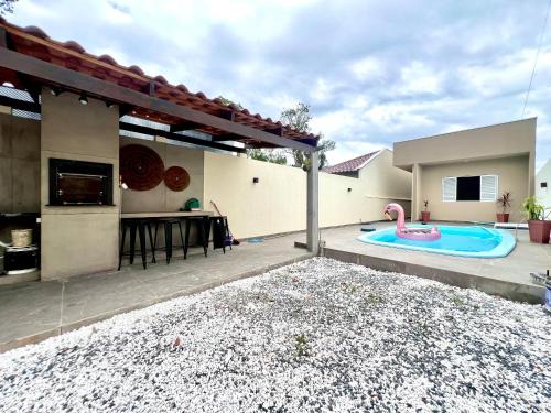 Guaratuba House | Casa com piscina , ar condicionado e churrasqueira no balneário Eliana